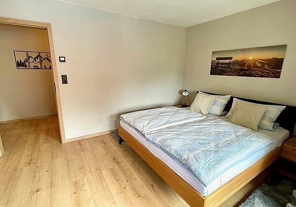 Doppelbett mit Blick in den Umkleideraum